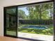 Backyard features a rectangular in-ground pool, well manicured landscaping, and privacy fence at 1719 Shoreham Dr, Charlotte, NC 28211
