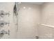 Contemporary shower with tiled walls, sleek fixtures, and a comfortable built-in bench at 1719 Shoreham Dr, Charlotte, NC 28211