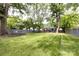 Secluded backyard oasis with expansive lawn, mature trees, and a cozy hammock for relaxation at 1816 Anderson St, Charlotte, NC 28205
