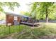 Lush backyard with mature trees surrounding the brick home at 1816 Anderson St, Charlotte, NC 28205