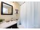 Well-maintained bathroom featuring vanity, toilet, and patterned shower curtain providing a clean and functional space at 1816 Anderson St, Charlotte, NC 28205