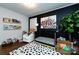 Cozy Bedroom with black accent wall, crib, decorative art, and a plush chair, creating a warm and inviting space at 1816 Anderson St, Charlotte, NC 28205