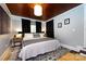 Charming bedroom features a spacious bed, wooden ceiling, and neutral color palette for a relaxing ambiance at 1816 Anderson St, Charlotte, NC 28205