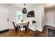 Charming dining nook with built-in seating, a modern pendant light, and a view through the window at 1816 Anderson St, Charlotte, NC 28205