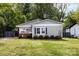 Charming house with mature trees surrounding the property with well-manicured shrubbery in the landscape at 1816 Anderson St, Charlotte, NC 28205