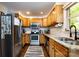 Functional kitchen with stainless steel appliances, light wood cabinets, and durable granite countertops at 1816 Anderson St, Charlotte, NC 28205