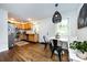 Open kitchen that transitions into a dining nook, featuring wood cabinetry, stainless appliances, and natural lighting at 1816 Anderson St, Charlotte, NC 28205