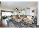 Inviting living room features a large sectional sofa, plush rug, and ample natural light from large windows at 1816 Anderson St, Charlotte, NC 28205