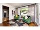 Cozy living room featuring wood floors, stylish seating, and ample natural light from large window at 1816 Anderson St, Charlotte, NC 28205