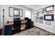 Bright home office featuring a spacious desk, dark wood flooring, and wall decor, creating an inviting and productive workspace at 1816 Anderson St, Charlotte, NC 28205