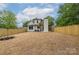 Large backyard with newly planted grass, privacy fence, and exterior view of the home at 1816 Parson St, Charlotte, NC 28205