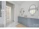 Bathroom featuring double sink vanity, marble counters and tile floor, with a walk-in closet at 1816 Parson St, Charlotte, NC 28205