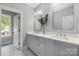 Bright bathroom with double sinks, modern fixtures, and stylish hexagon tile flooring at 1816 Parson St, Charlotte, NC 28205