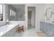 Elegant bathroom featuring marble tile, a soaking tub and a walk-in shower at 1816 Parson St, Charlotte, NC 28205