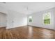 Bright bedroom with hardwood floors, white walls, ceiling fan and bright, natural light at 1816 Parson St, Charlotte, NC 28205