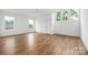 Open bedroom with hardwood floors, ceiling fan, white walls and bright, natural light at 1816 Parson St, Charlotte, NC 28205