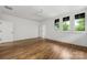 Spacious bedroom with hardwood floors, white walls, ceiling fan and bright, natural light at 1816 Parson St, Charlotte, NC 28205