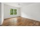 Bedroom with wood floors, neutral colors and a window with a wooded view at 1816 Parson St, Charlotte, NC 28205