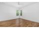 Bedroom with a ceiling fan, wood floors and bright light from large windows at 1816 Parson St, Charlotte, NC 28205