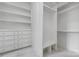 Walk-in closet with custom shelving, drawers, and seating for organized storage at 1816 Parson St, Charlotte, NC 28205