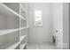 Spacious walk-in closet with built-in shelving offering ample storage and organization at 1816 Parson St, Charlotte, NC 28205