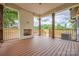 Inviting covered deck with a brick fireplace, wooden columns, and outdoor living space at 1816 Parson St, Charlotte, NC 28205
