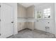 Laundry room with built-in cabinets, ample countertop space, and natural light from the window at 1816 Parson St, Charlotte, NC 28205