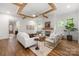 Bright living room with hardwood floors, fireplace, and stylish furniture under exposed beams at 1816 Parson St, Charlotte, NC 28205