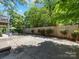 Large backyard features a concrete patio, a well-maintained lawn, and a wood fence at 1900 Nassau Blvd, Charlotte, NC 28205