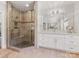 Bathroom featuring a glass enclosed shower with tile surround and a double sink vanity with large mirror at 1900 Nassau Blvd, Charlotte, NC 28205