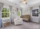 Bright Bedroom with neutral walls, carpet, ceiling fan, and multiple windows for natural light at 1900 Nassau Blvd, Charlotte, NC 28205