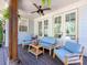 Relaxing covered porch featuring comfortable seating, a ceiling fan, and elegant decor, perfect for outdoor living at 1900 Nassau Blvd, Charlotte, NC 28205