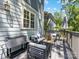 Outdoor deck with stylish seating, a cooler, and views of the backyard and surrounding greenery at 1900 Nassau Blvd, Charlotte, NC 28205