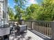 Scenic outdoor deck with comfortable seating, shaded by a patio umbrella, overlooking the lush greenery at 1900 Nassau Blvd, Charlotte, NC 28205