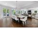 Spacious dining room boasts modern lighting, hardwood floors, and access to an outdoor patio at 1900 Nassau Blvd, Charlotte, NC 28205