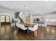 Grand foyer combines dining, kitchen, and staircase, featuring modern light fixtures and hardwood floors at 1900 Nassau Blvd, Charlotte, NC 28205