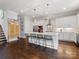 Gourmet kitchen features a large island with seating, stainless steel appliances, and modern lighting at 1900 Nassau Blvd, Charlotte, NC 28205