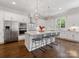 Modern kitchen featuring stainless steel appliances, white cabinets, and large island with barstool seating at 1900 Nassau Blvd, Charlotte, NC 28205