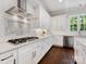 Updated kitchen with gas range, stainless steel appliances, and subway tile backsplash at 1900 Nassau Blvd, Charlotte, NC 28205