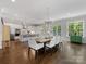 Open concept kitchen and dining area with modern lighting, white cabinets, and stainless steel appliances at 1900 Nassau Blvd, Charlotte, NC 28205