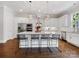 Bright kitchen features island with seating, pendant lighting, stainless steel appliances, and white cabinetry at 1900 Nassau Blvd, Charlotte, NC 28205