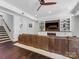 Spacious living room featuring hardwood floors, built-in shelves, and a brown leather couch at 1900 Nassau Blvd, Charlotte, NC 28205