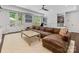 Inviting living room boasting a brown leather couch, large windows, and ample natural light at 1900 Nassau Blvd, Charlotte, NC 28205