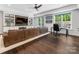 Bright living room with hardwood floors, built-in shelves, and a comfortable brown leather couch at 1900 Nassau Blvd, Charlotte, NC 28205