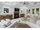 Open-concept living room with hardwood floors, a fireplace, tray ceilings, and ample natural light at 1900 Nassau Blvd, Charlotte, NC 28205