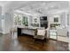 Bright open-concept living room with hardwood floors, tray ceilings, a fireplace, and large windows at 1900 Nassau Blvd, Charlotte, NC 28205
