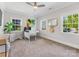 Bright home office with neutral walls, carpet, ceiling fan, and multiple windows for natural light at 1900 Nassau Blvd, Charlotte, NC 28205