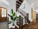 Staircase featuring wood steps, dark iron railings, and a potted plant in the entry at 1900 Nassau Blvd, Charlotte, NC 28205