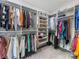 Organized walk-in closet with multiple shelves, hanging racks, and storage baskets for ample storage at 1900 Nassau Blvd, Charlotte, NC 28205