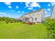 Spacious backyard featuring a well-maintained lawn, flower beds, and a screened porch at 2007 Lydney Cir, Waxhaw, NC 28173